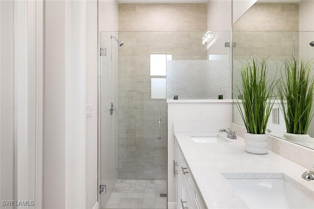 bathroom featuring double vanity, a shower stall, and a sink