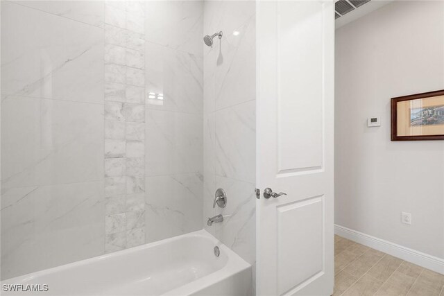 bathroom with  shower combination, visible vents, and baseboards