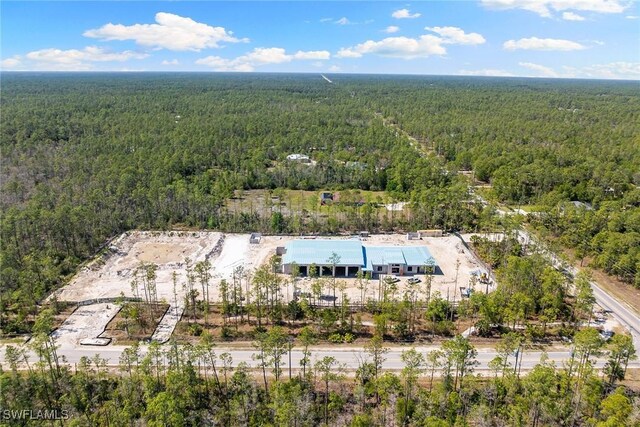 aerial view featuring a wooded view