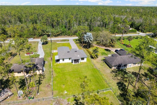 drone / aerial view featuring a wooded view