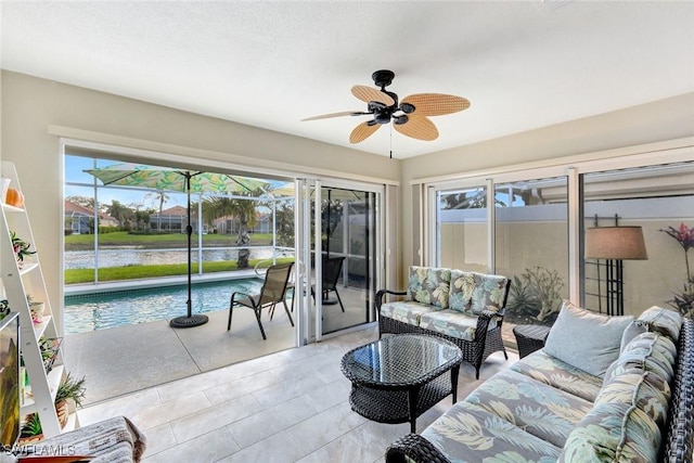 sunroom featuring ceiling fan and plenty of natural light