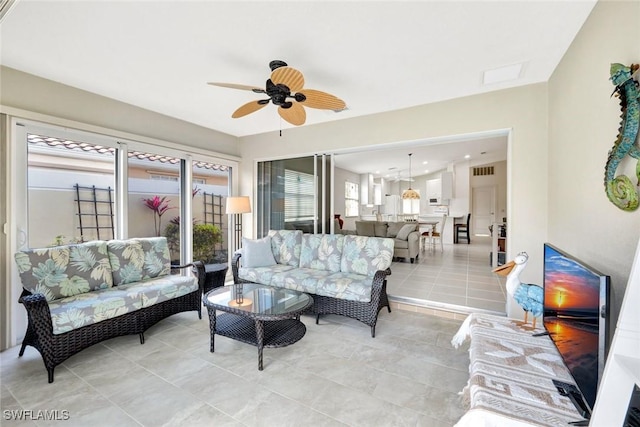 living area featuring visible vents, ceiling fan, and light tile patterned floors