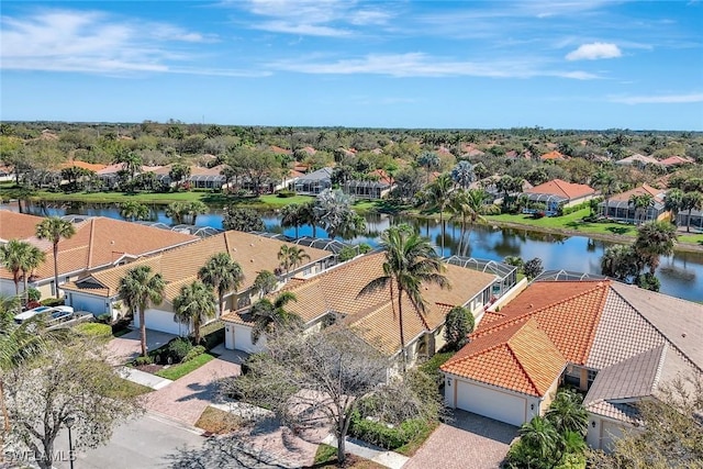 drone / aerial view featuring a residential view and a water view