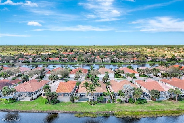 drone / aerial view with a residential view and a water view