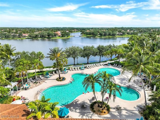 community pool with a water view and a patio area