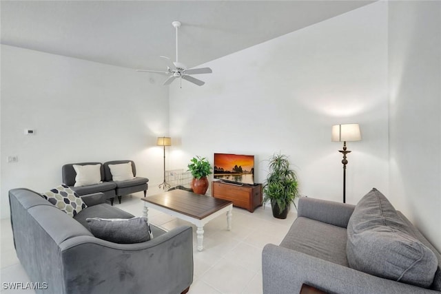 living room featuring ceiling fan and a towering ceiling