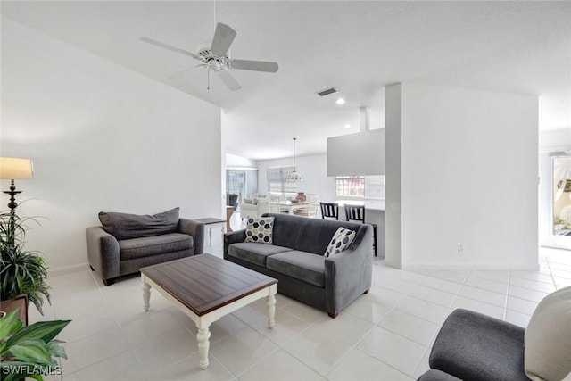 living room featuring baseboards, light tile patterned flooring, visible vents, and a ceiling fan