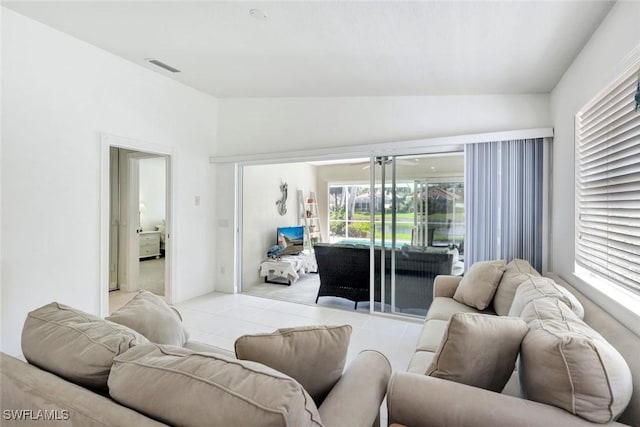 living area featuring vaulted ceiling and visible vents