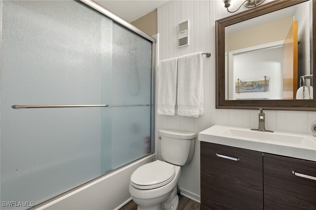 full bath featuring toilet, enclosed tub / shower combo, and vanity