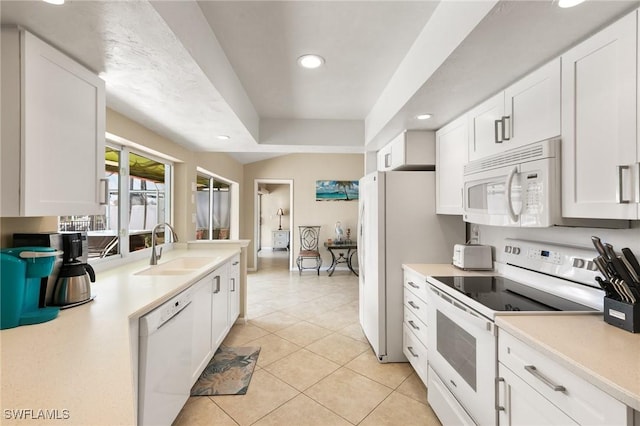 kitchen with light countertops, white appliances, white cabinets, and a sink