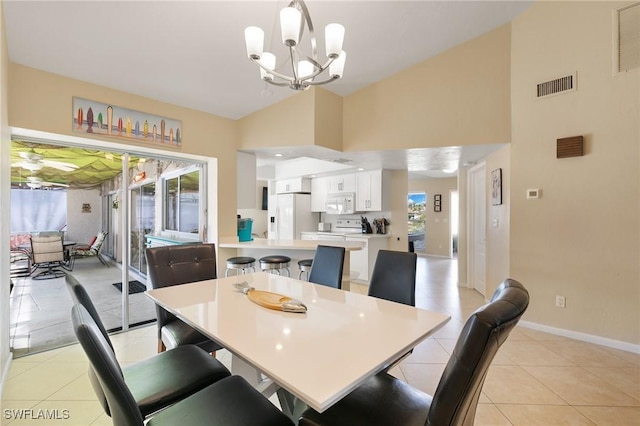 dining room featuring light tile patterned floors, high vaulted ceiling, visible vents, baseboards, and an inviting chandelier