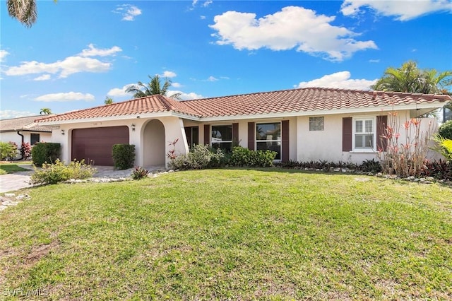 view of front of property featuring an attached garage, a tiled roof, a front lawn, and stucco siding