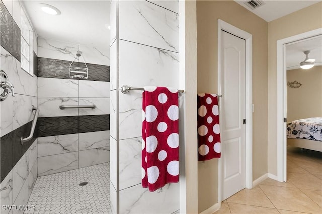 full bathroom featuring tiled shower, connected bathroom, visible vents, and baseboards