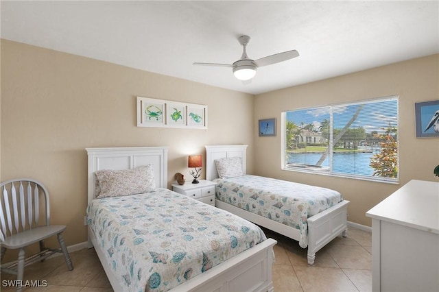 bedroom with light tile patterned flooring, a ceiling fan, and baseboards