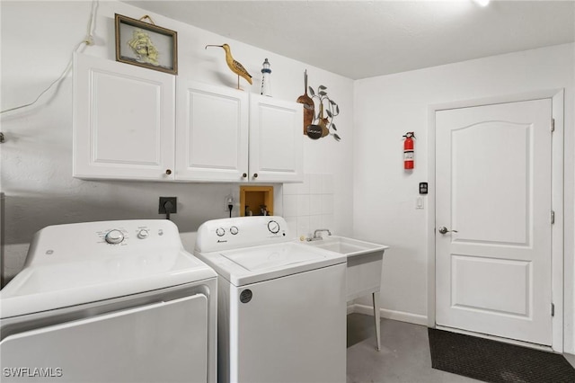 laundry room with cabinet space, washer and clothes dryer, and baseboards