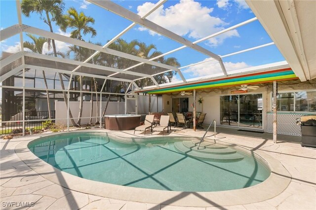 pool with ceiling fan, a patio, glass enclosure, fence, and a hot tub