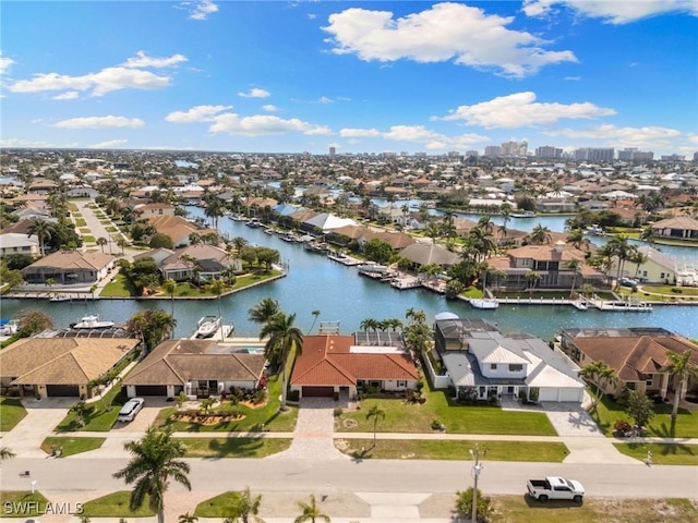 birds eye view of property with a water view and a residential view