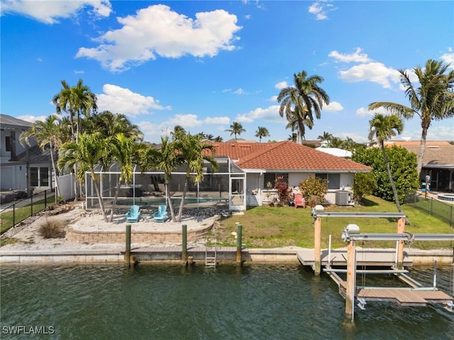 view of dock featuring glass enclosure, a water view, fence, a lawn, and a fenced in pool