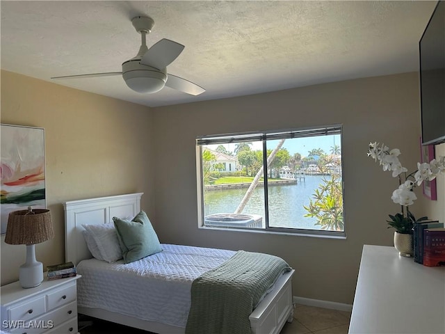 1145 Shenandoah Ct, Marco Island, FL 34145 - bedroom with a ceiling fan, light tile patterned floors, and a textured ceiling