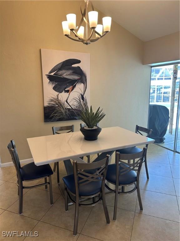 1145 Shenandoah Ct, Marco Island, FL 34145 - dining area with a chandelier and light tile patterned floors