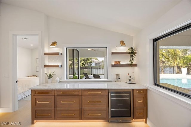 bar featuring wine cooler and vaulted ceiling