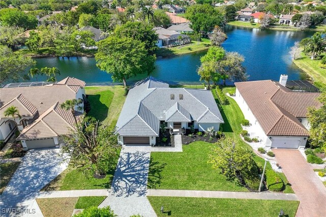 drone / aerial view with a residential view and a water view