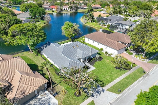 drone / aerial view featuring a water view and a residential view