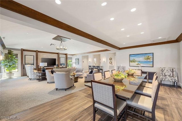 dining room with recessed lighting, crown molding, light wood-style flooring, and an inviting chandelier