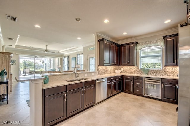 kitchen featuring beverage cooler, a sink, visible vents, appliances with stainless steel finishes, and a raised ceiling