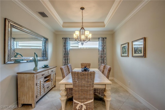 dining space with a chandelier, light tile patterned floors, baseboards, ornamental molding, and a raised ceiling