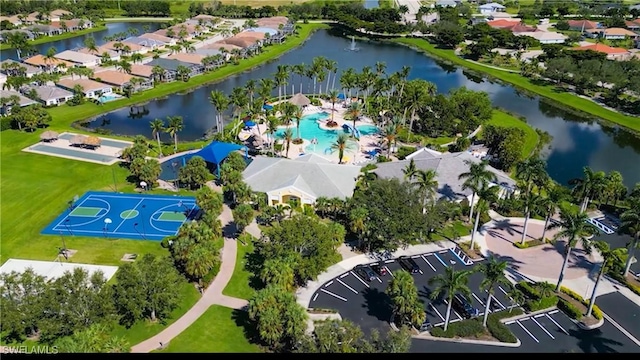 drone / aerial view featuring a residential view and a water view