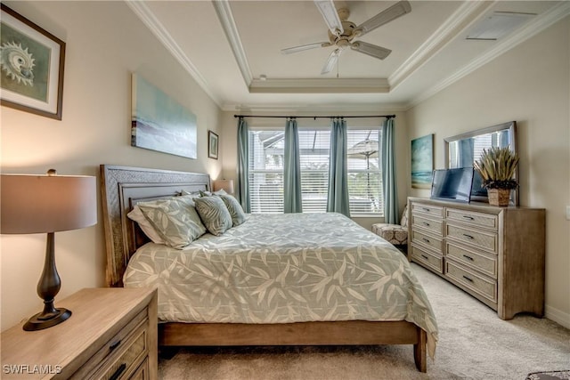 bedroom featuring light carpet, a tray ceiling, a ceiling fan, and ornamental molding