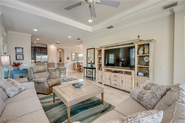 living area featuring ornamental molding, visible vents, arched walkways, and recessed lighting