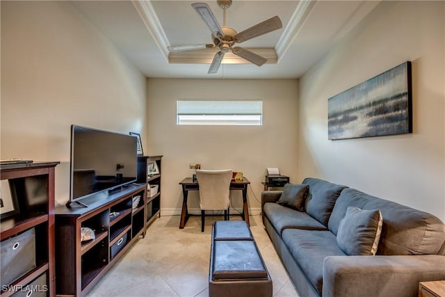 living room with ornamental molding, a tray ceiling, baseboards, and a ceiling fan