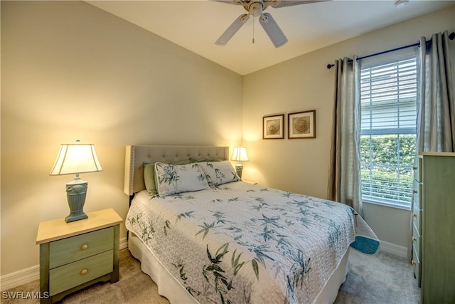 bedroom featuring light carpet, baseboards, and multiple windows