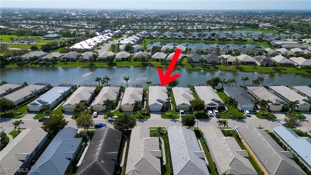 birds eye view of property featuring a water view and a residential view