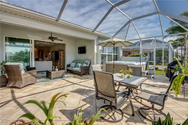 view of patio with outdoor dining area, ceiling fan, a hot tub, and an outdoor hangout area