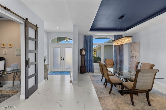 entrance foyer with marble finish floor, french doors, a barn door, and baseboards