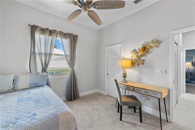 bedroom featuring ceiling fan, light colored carpet, and baseboards