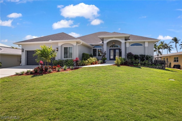 view of front of property with french doors, a front lawn, an attached garage, and stucco siding