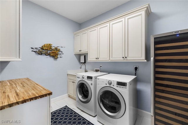 laundry area with cabinet space, baseboards, marble finish floor, separate washer and dryer, and a sink