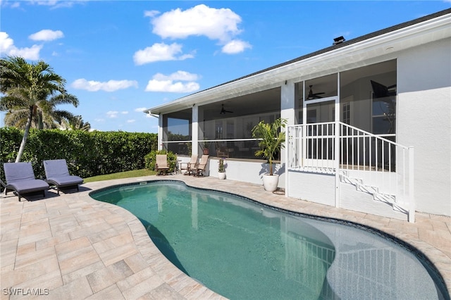 view of pool with a fenced in pool, a sunroom, a patio, and ceiling fan