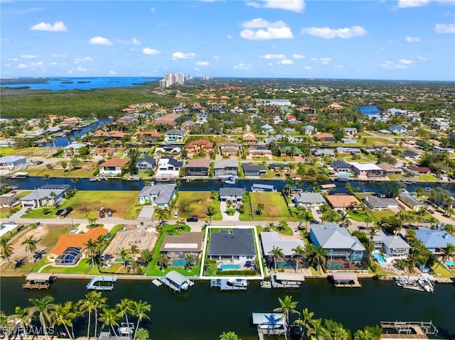 bird's eye view featuring a water view and a residential view