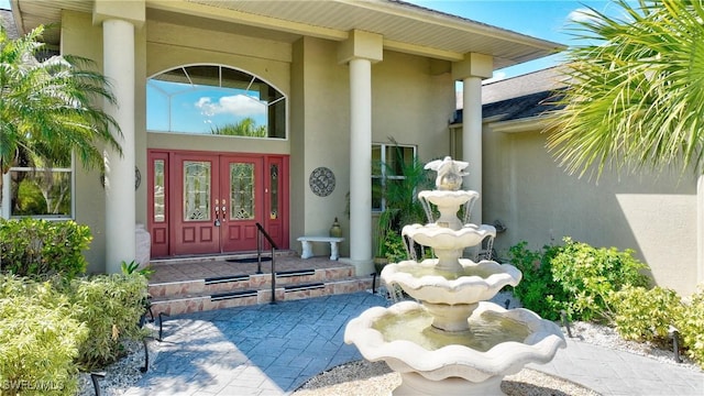 entrance to property with french doors and stucco siding