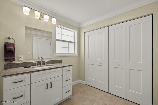 bathroom featuring baseboards, crown molding, and vanity