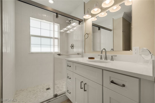 full bathroom with a stall shower and vanity