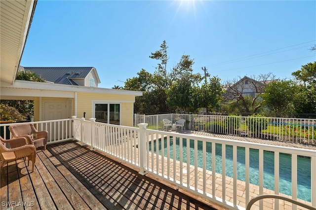 wooden deck with fence and a fenced in pool