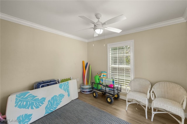 interior space with wood finished floors, a ceiling fan, and crown molding