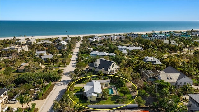 bird's eye view with a beach view, a water view, and a residential view