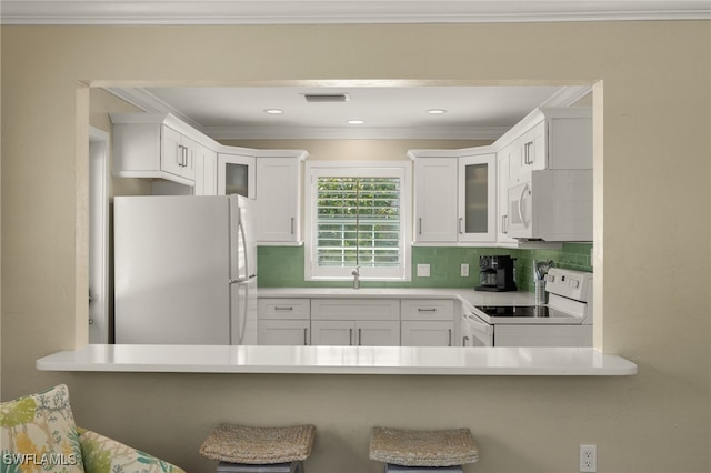 kitchen featuring white appliances, visible vents, decorative backsplash, glass insert cabinets, and white cabinetry